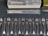 a lot of forks and spoons that are on the table