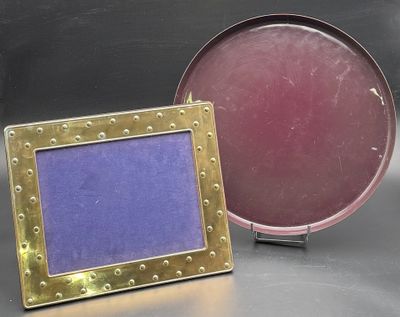purple and gold picture frames with riveted edges on a metal surface