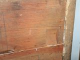 a picture of a wooden door with peeling paint on it