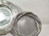 a silver plate and a silver plate sitting on a table