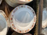many plates that are stacked together on a table