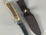 a knife that is laying next to a knife holder