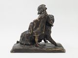 bronze statue of a man and a dog on a white background