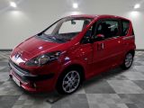a picture of a red car parked on a checkered floor