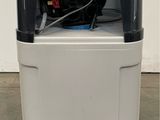 an image of a small white and black machine in a room
