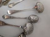 five spoons and two spoons sitting on a table