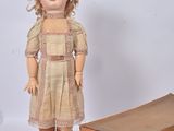 a doll that is standing next to a box