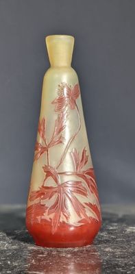 a red and yellow vase sitting on a table