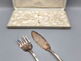 silverware in a silver case and two forks and a spoon