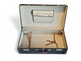 an open suitcase with a pair of glasses in it