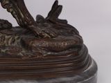 a bronze statue of a man on a horse on a marble base