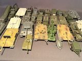 a lot of toy army vehicles on display on a table
