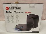 the box of the robot vacuum is open on the bed
