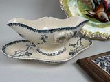 a plate with a bird on it and a bowl with a bird on it