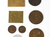 some coins and a coin are sitting on a white surface