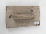 a small piece of wood with a piece of wood sticking out of it
