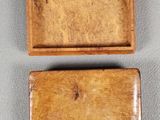 two small wooden boxes sitting on top of a gray surface