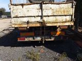 a dump truck that is parked in the dirt