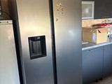 several stainless steel refrigerators and freezers are in a kitchen