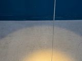 a floor lamp that is on a concrete floor