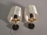 pair of silver colored lamps with a wooden cross on each of them