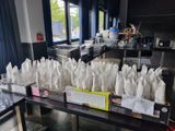 many bags of food sitting on a table in the kitchen