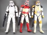 star wars action figures are lined up against a gray background