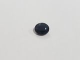 a black sapphire stone on a white surface