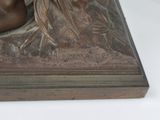 a bronze statue of a horse that is sitting on a table