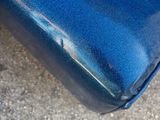 a close up view of a blue suitcase on the ground
