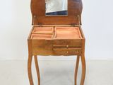 a small wooden table with a mirror on top of it