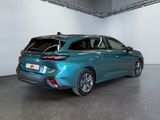 the rear end of a blue car parked in a garage