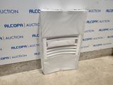 a plastic chair that is sitting in front of a wall