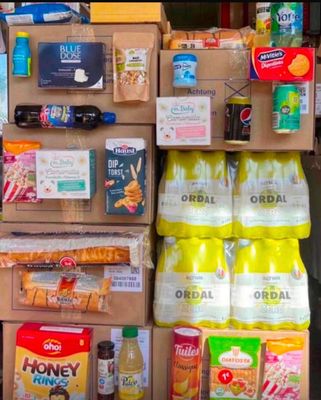 boxes of food and drinks are stacked on top of each other