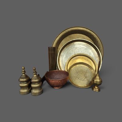 an image of a group of brass objects on a gray surface