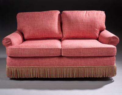 an image of a pink couch with fringes on it