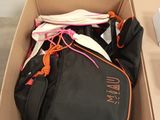 a cardboard box with a bunch of clothes in it