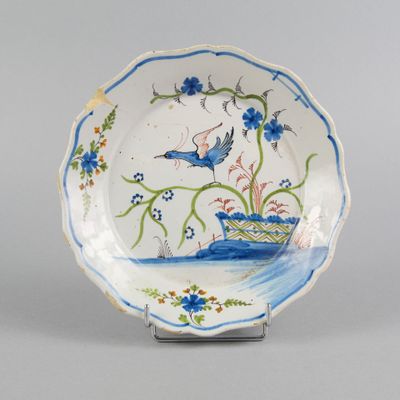 l'image d'une assiette bleue et blanche sur laquelle figure un oiseau