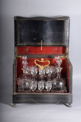 a wooden box with a bunch of wine glasses inside of it