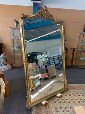 un grand miroir posé au milieu d'une pièce
