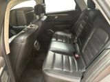 the back seats of a car are empty and the seats are black