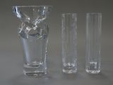 three glass vases sitting next to each other on a table