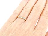 a woman ' s hand with a diamond ring on it