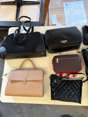 a lot of purses that are on a table