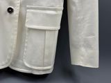 an image of a white jacket with buttons on the lapel