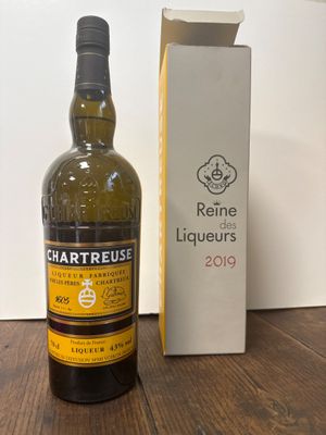 une bouteille de vin posée sur une table à côté d'une boîte