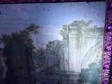 painting of a castle in a purple frame on a wall