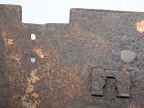 a rusted metal plate with a hole in the middle