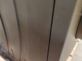 an image of a stainless steel refrigerator on a pallet