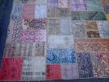 an image of a patchwork rug on the ground